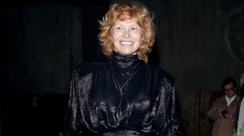Pamela Anderson red hair transformation at Paris Fashion Week, debuting her new strawberry-red hairstyle in black Balenciaga outfit.